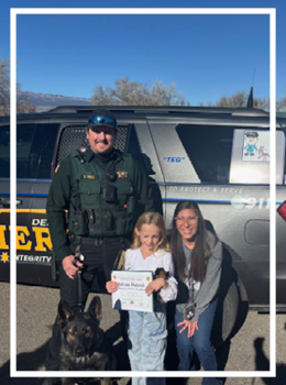 Deputy Ruble, K-9 TEG and Emma with her winning art